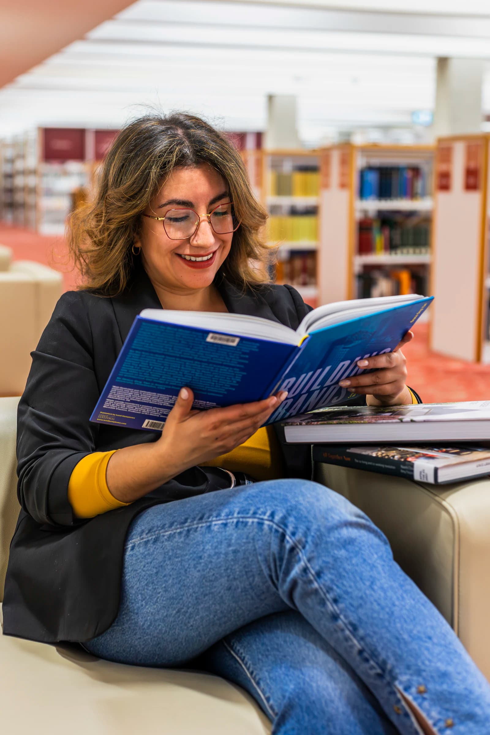 Smiling student reading a book